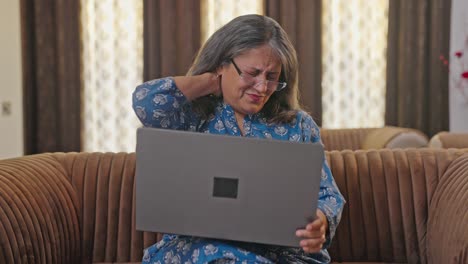 Aged-Indian-woman-suffering-from-neck-pain-after-working-long-hours