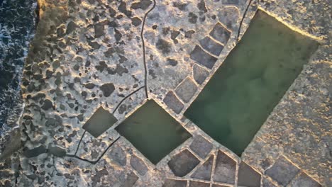 aerial shot of of salt pans near the sea in the malta