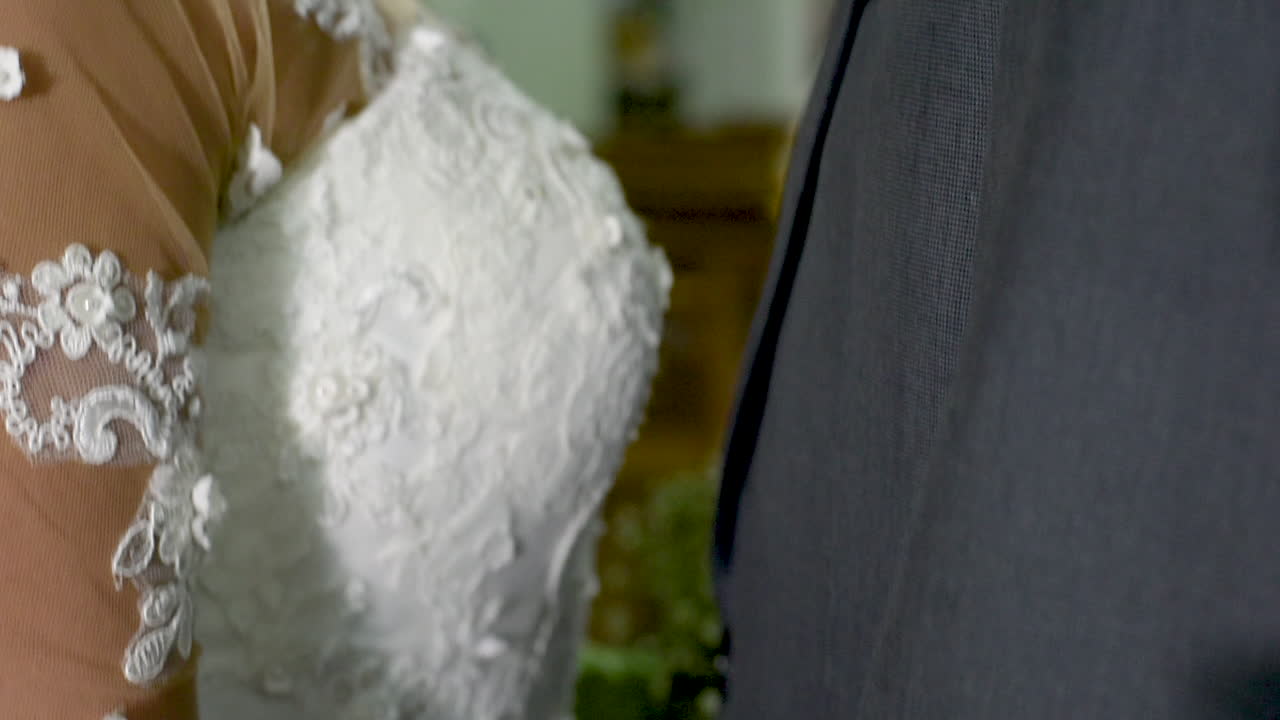 Married couple holding hands in church after marriage