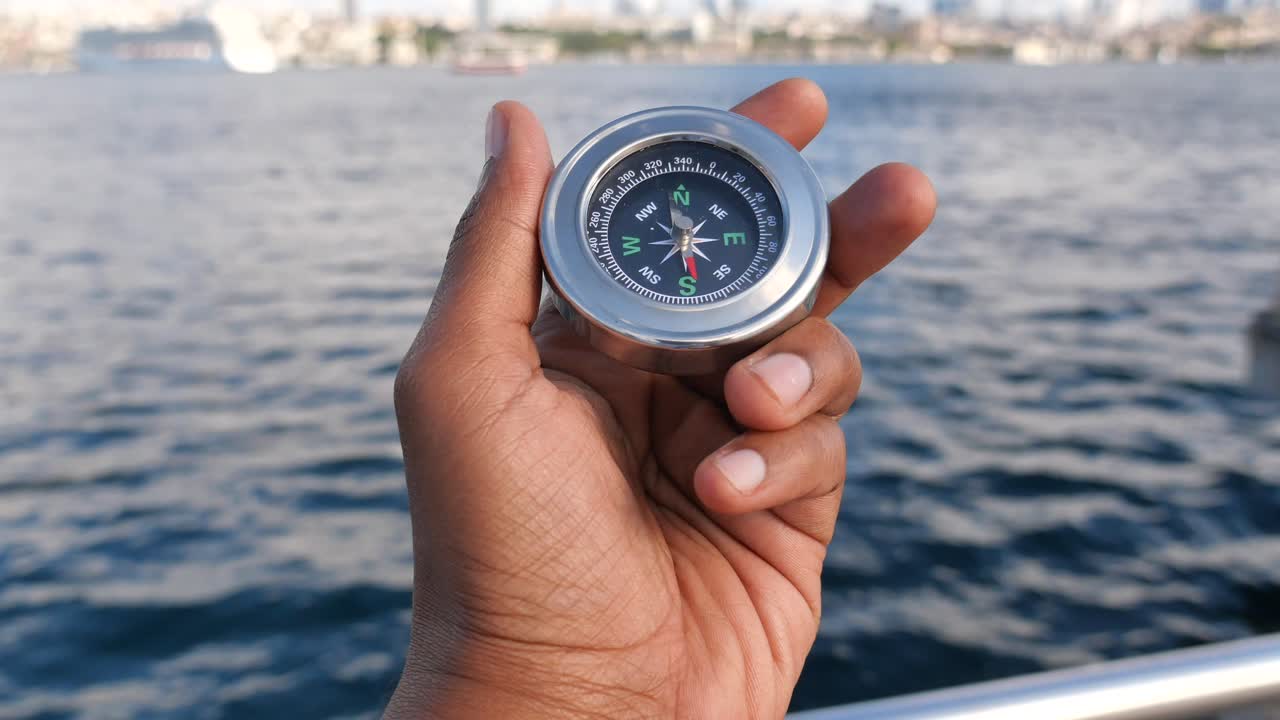 Compass in Hand by the Sea