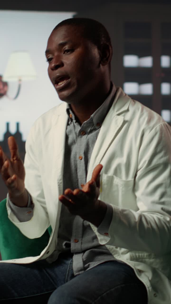 African Man in White Coat Speaking and Gesturing