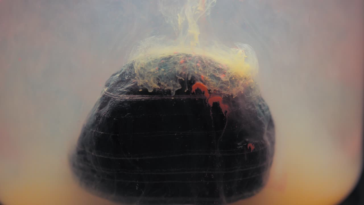 Slowmotion paint floating inside water tank, beautiful layered rock. Stable shot with the Sony a7iii.