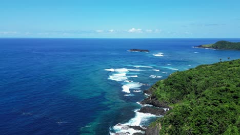 panoramic aerial above crashing waves on outside point break on baras catanduanes coastline