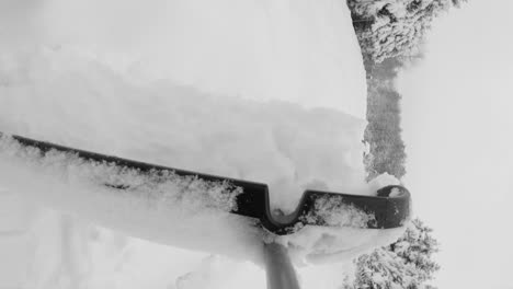 removing fresh snow from walkway after winter blizzard, pov