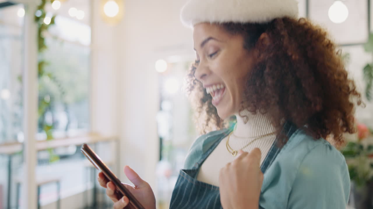 Excited woman in santa hat using mobile phone