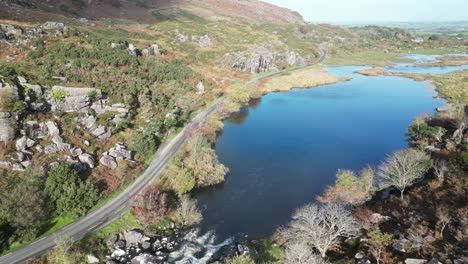 aerial footage of the gap of dunloe and the river loe and rocky cliffs