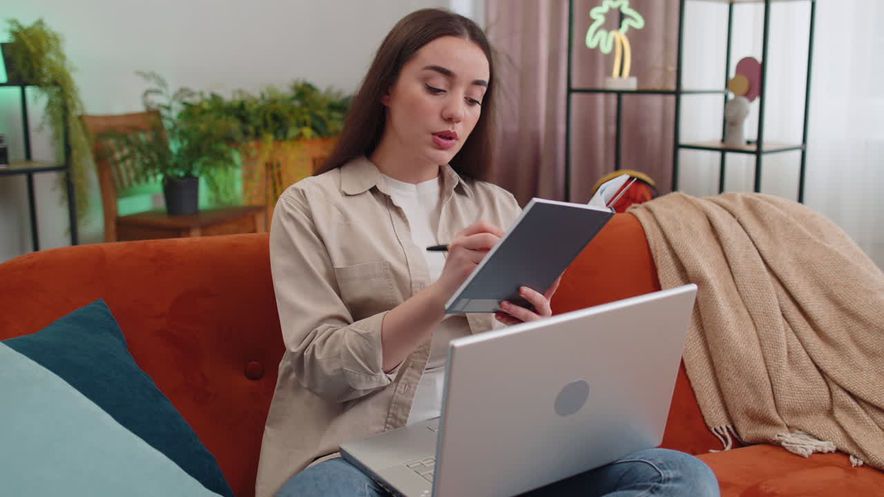 Girl making online conference video call talking to laptop webcam elearning in remote chat at home