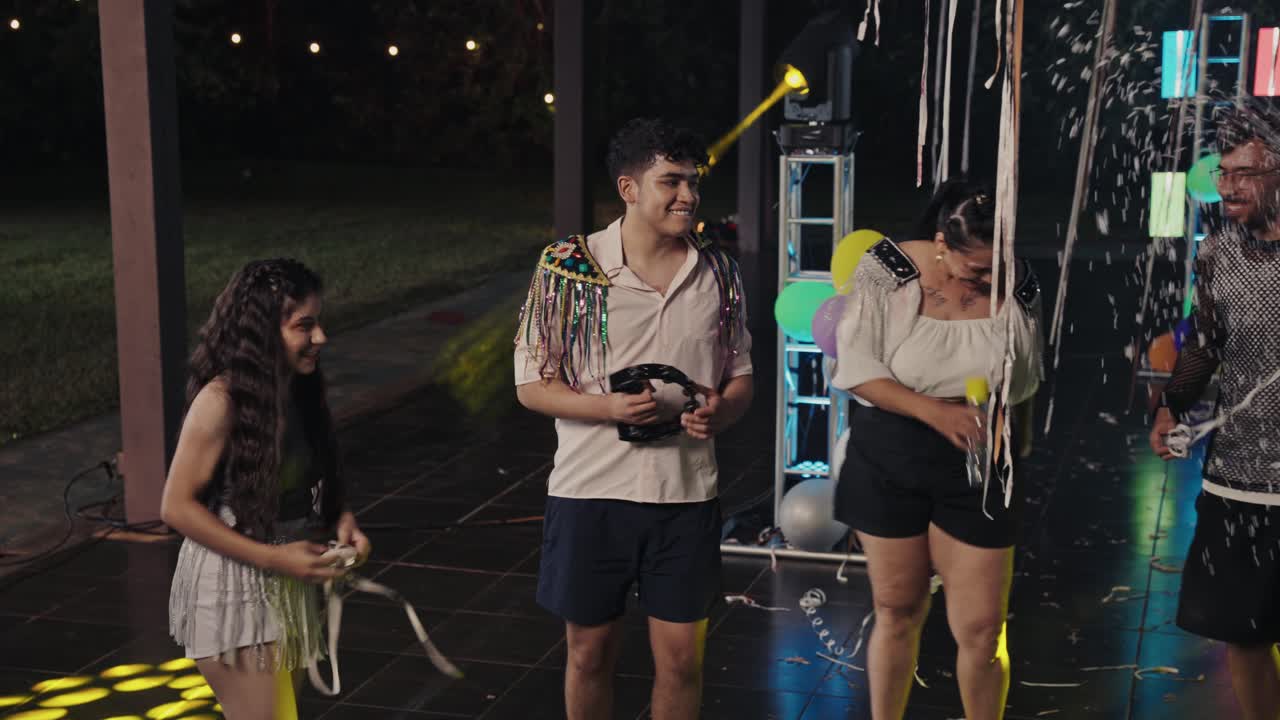 Young Adults Celebrate with Confetti at a Night Party