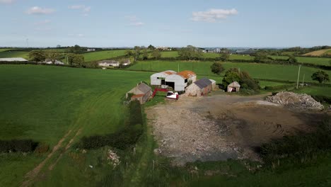 rotating aerial of barns and farmhouse in irish countryside