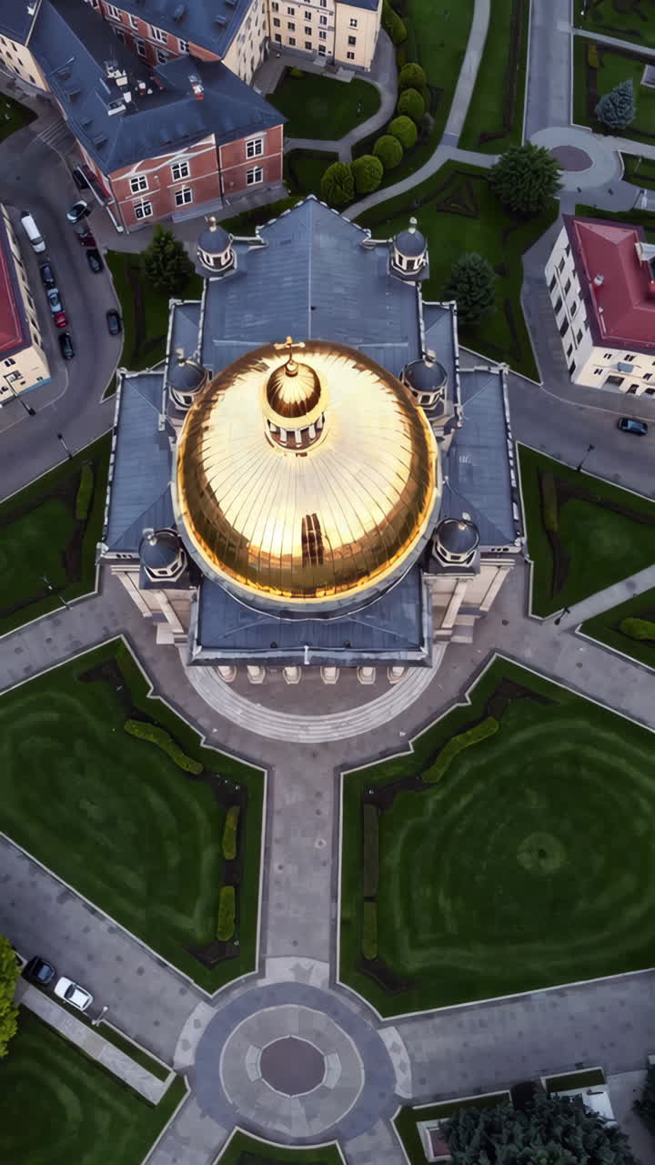 Aerial view of a golden-domed church in a city park