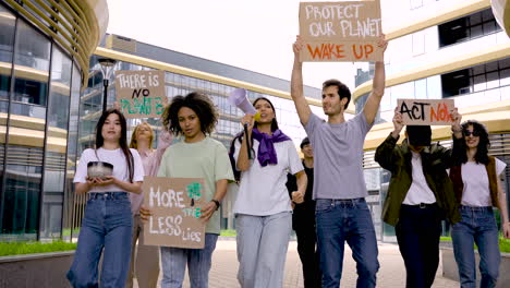 group of people in a protest using megaphones and holding placards 1