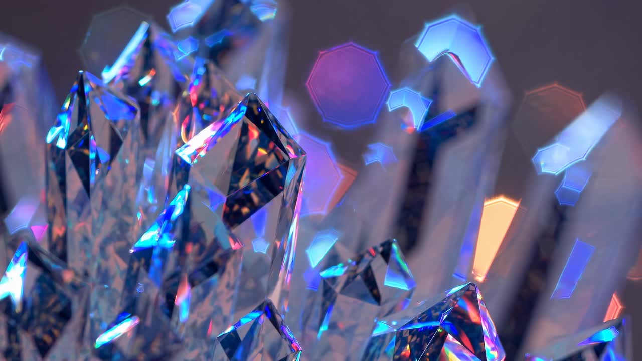 Close-up video shot of sparkling blue crystals with a shallow depth of field, capturing vibrant