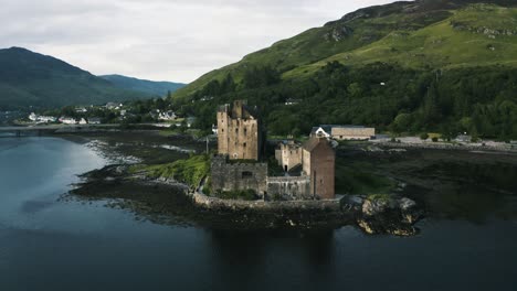 drone shot pulling away from an ancient abandoned castle in scotland