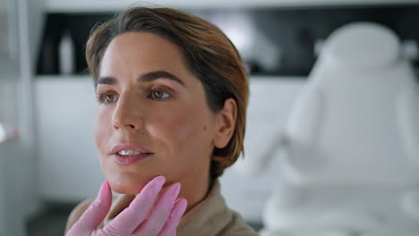 beautician checking skin health woman in beauty clinic closeup. facial examining