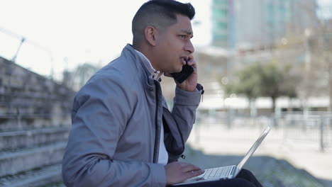 Confident-businessman-working-with-laptop-outdoor