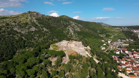 historic fortica fortress, spanish fortress in the hilltop over hvar town in croatia. - aerial shot