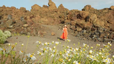 Front-view-of-female-tourist-wearing-sun-hat-in-volcanic-Tenerife