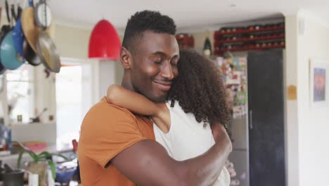 african american father and daughter hugging