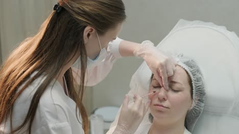 cosmetologist performing facial injection procedure