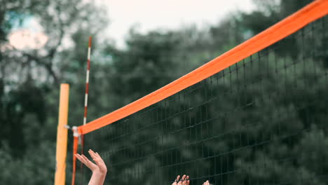 Junge-Frau-Spielt-In-Einer-Mannschaft-Volleyball-Am-Strand-Und-Führt-Einen-Angriff-Durch,-Indem-Sie-Den-Ball-Schlägt.-Mädchen-Schlägt-In-Zeitlupe-Den-Ball-Und-Führt-Einen-Angriff-Durch-Das-Netz-Aus.