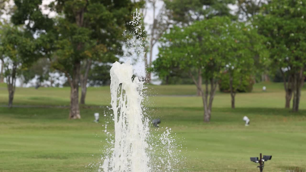Water jet fluctuates in a park fountain.