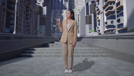 business woman presenting in front of modern city buildings