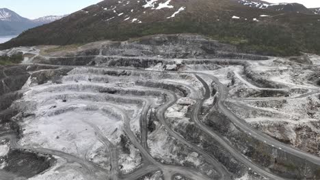 limestone quarry and limestone mining site for company visnes kalk as between molde and kristiansund in norway - aerial showing carved out and damaged mountain