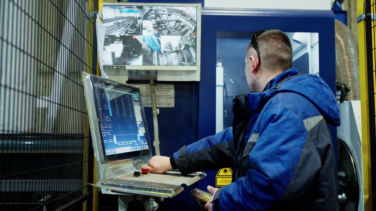 Worker operating machine in factory