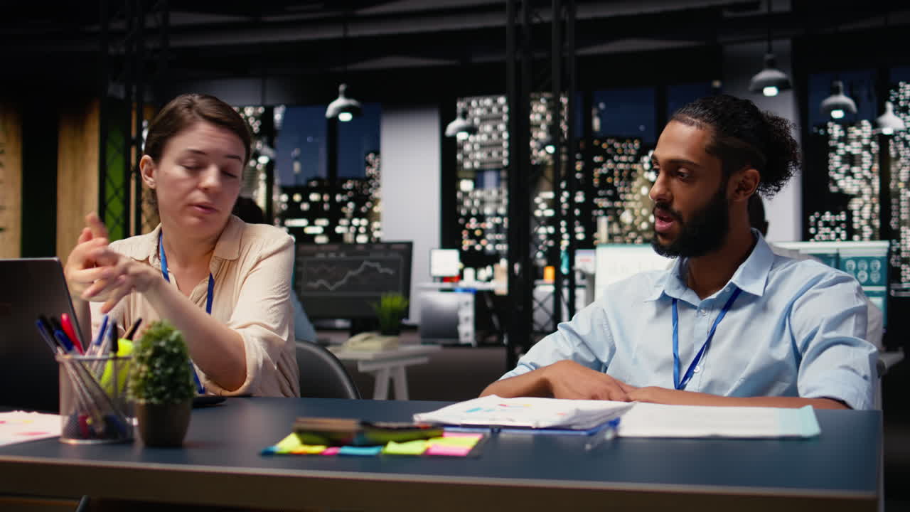 Arab man in wheelchair collaborating with woman in modern office