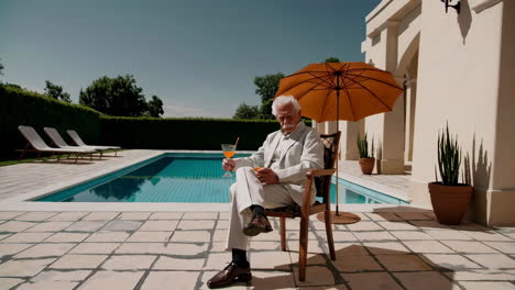 senior man relaxing by the pool