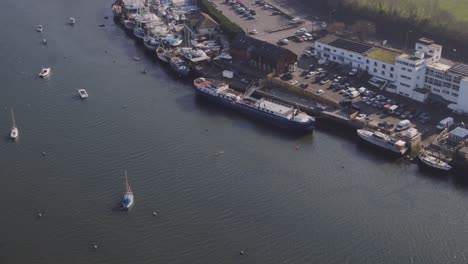aerial of the penryn river near falmouth, a pod of dolphins cohabiting and playing in the river not far from the marina.