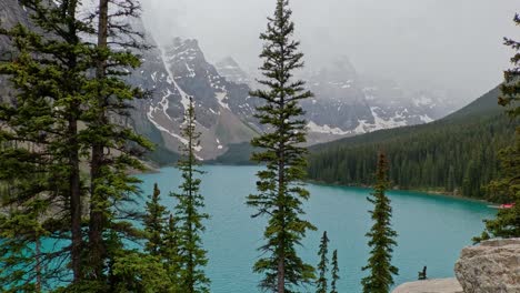 mountain side view of the beautiful azure blue waters of moriane lake in banff national park in alberta canada