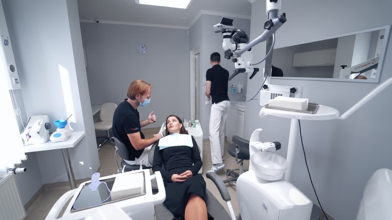 Stomatology interior of dental clinic. Female in stomatological cabinet with dentists