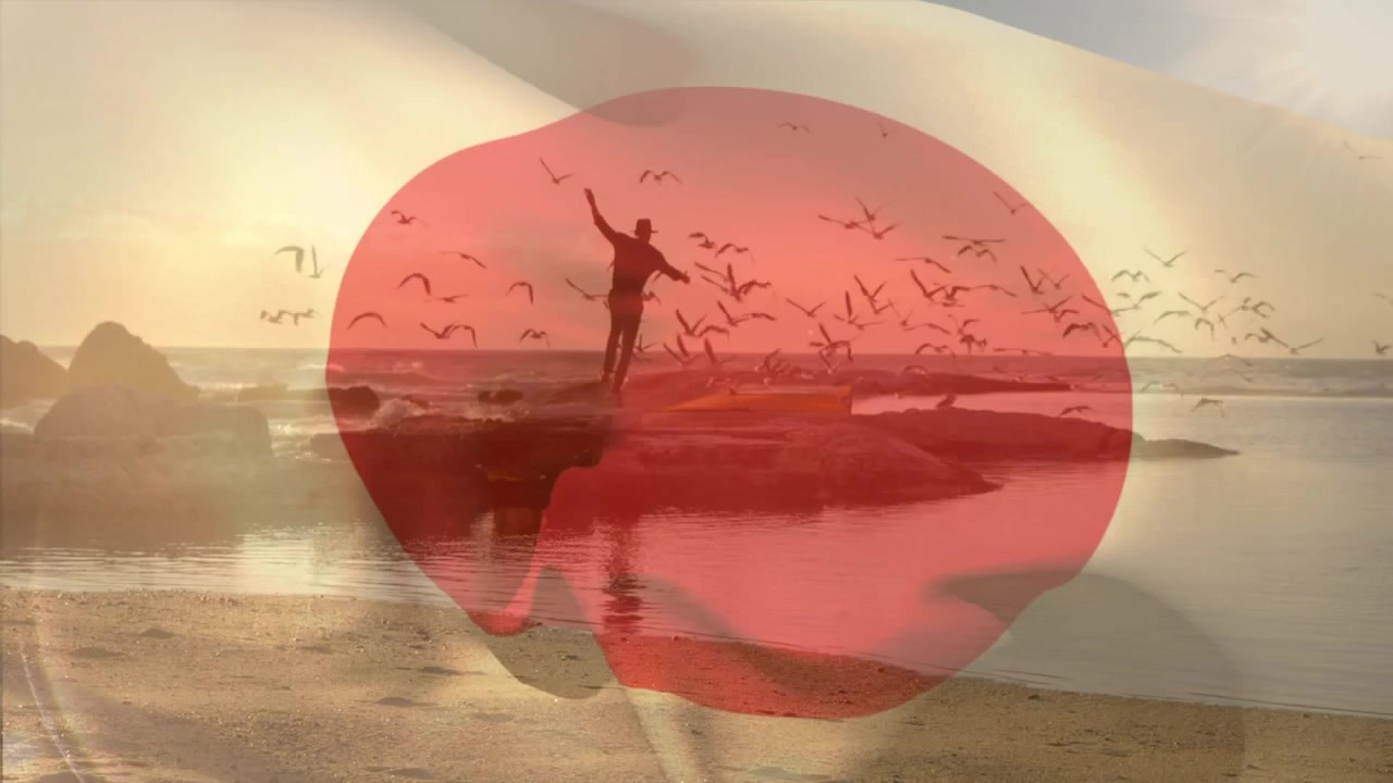 Animation av Japans flagga över en man på stranden