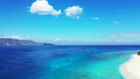 beautiful tourist destination with white sand and cloudy blue sky above, padar island, indonesia - aerial shot