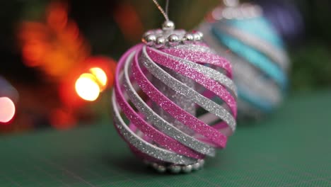 pink and blue glitter foam christmas ornaments, on a green cutting mat