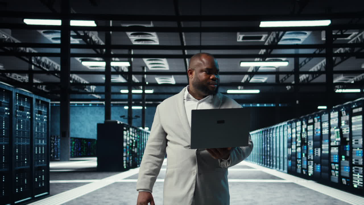 Vertical video Data center computer scientist using laptop to manage system stability