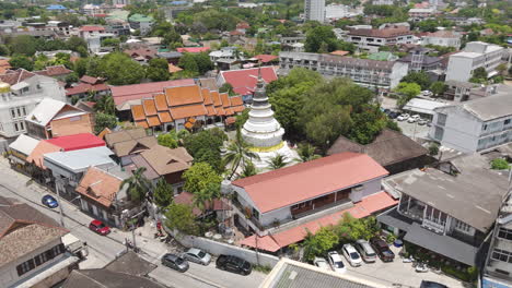 buddhist temple stupa of wat ket karam along charoenrad road, muang, chiang mai, thailand. aerial drone shot