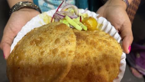 fish kachori held by a girl at night in kolkata