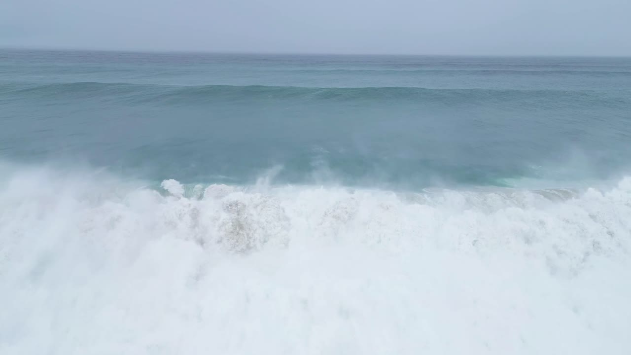 Majestic slow-motion ocean waves crashing at the beach in Aljezur, Portugal