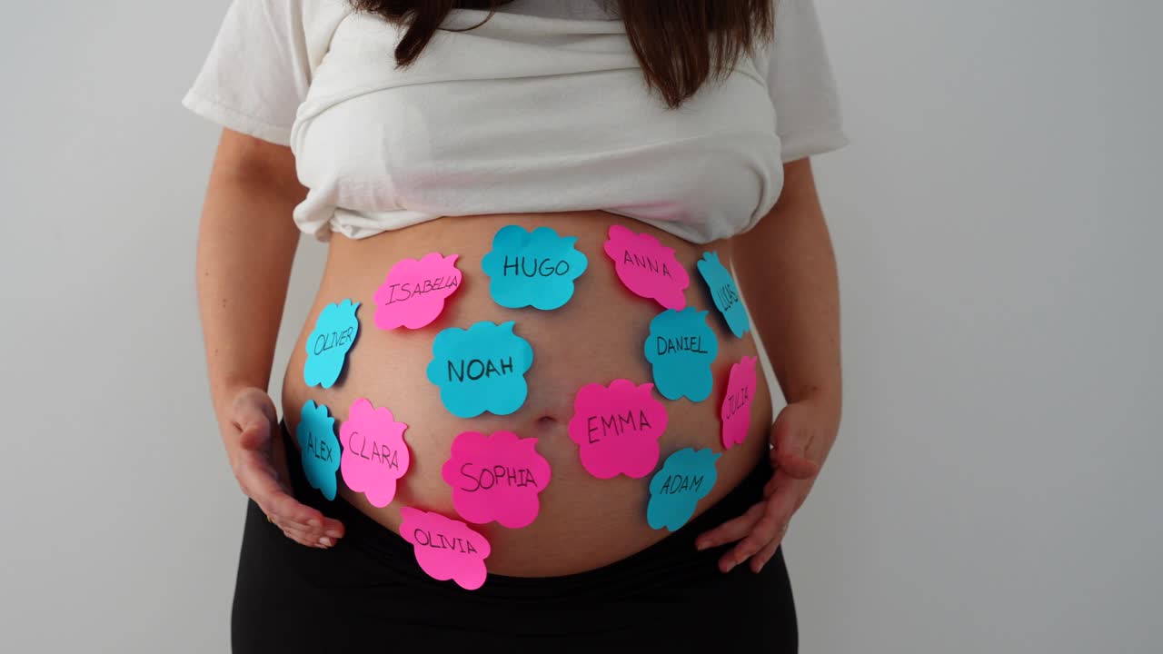 Pregnant belly with sticky notes of baby names, woman hesitating with raised arms