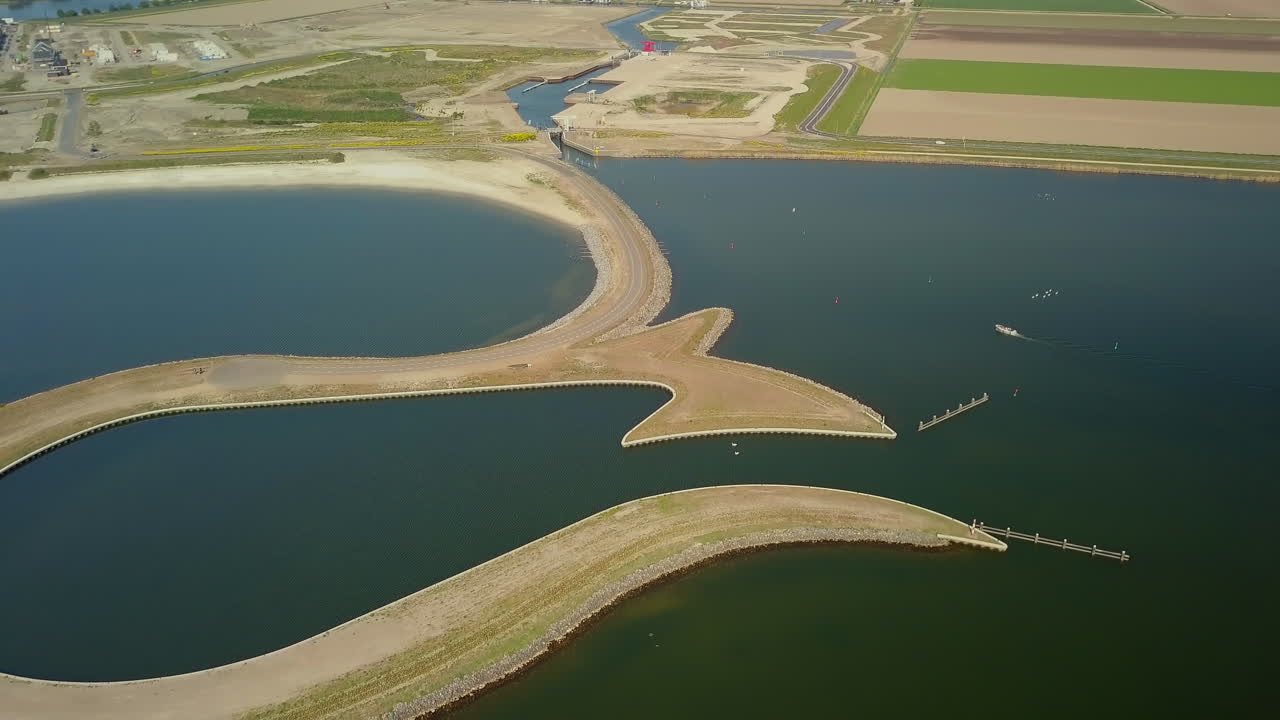 aerial drone shot of flying backward over the manmade Tulip Island located at the coastline of the Zeewolde, Flevoland, the Netherlands.