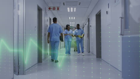animation of heart rate montior against diverse male and female doctors discussing at hospital