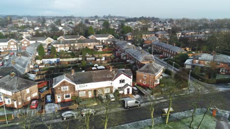 aerial view frosty white winter residential town neighbourhood rooftops panning left