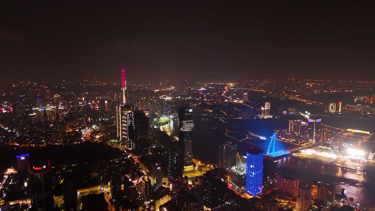Expansive drone shot of Saigon’s skyline with the illuminated Landmark 81, vibrant bridges, and the glowing Saigon River, Vietnam