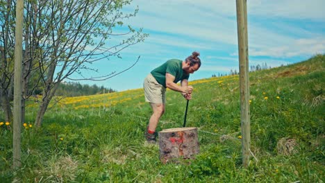 man building fence in the yard in countryside norway