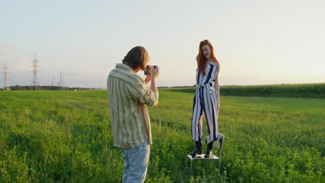 photographer taking a photo of a model in a field