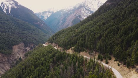 Rising-aerial-drone-shot-of-mountain-road-near-Duffey-Lake,-British-Columbia