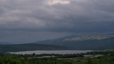 time lapse of dark grey storm clouds blowing over dovre mountains norway