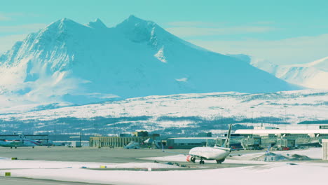 a passenger plane arrives at tromso airport, norway, in winter